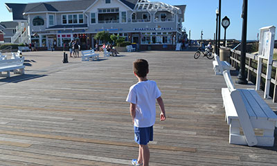 Small boy on boardwalk