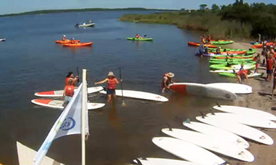 Group of people with kayaks and SUP